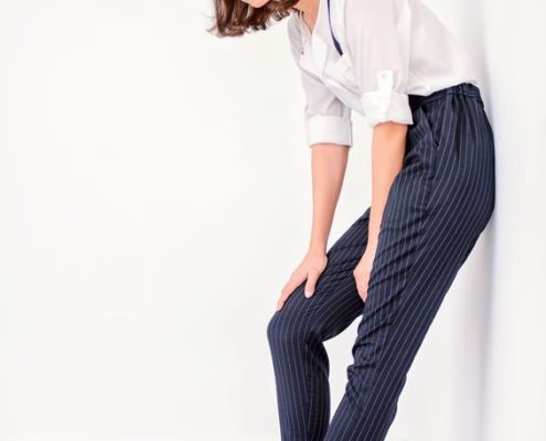 Woman modeling suspenders and striped pants
