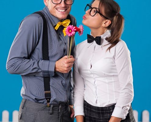 Models wearing costumes and wearing suspenders and a bow tie