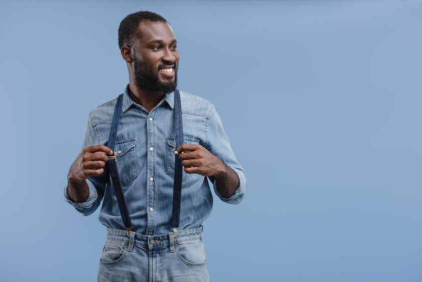 Man wearing a denim outfit with denim suspenders and denim jeans