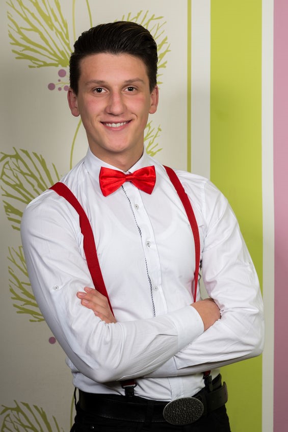 Man wearing red suspenders with a red bow tie and a white dress shirt