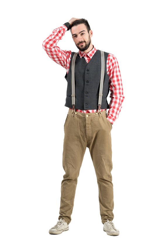 A man with striped suspenders, plaid shirt, and a grey vest