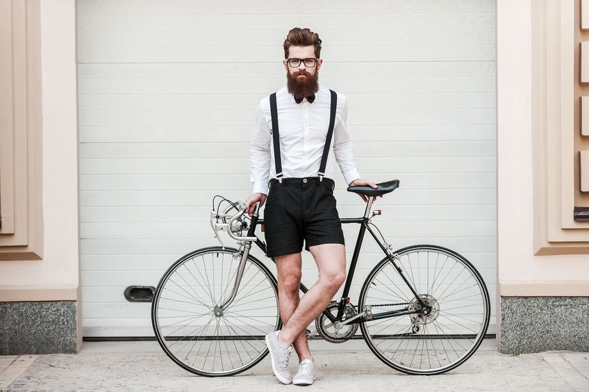 Man wearing black suspenders and black shorts with a white dress shirt